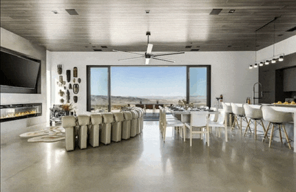 a living room and dining room in a house with a ceiling fan