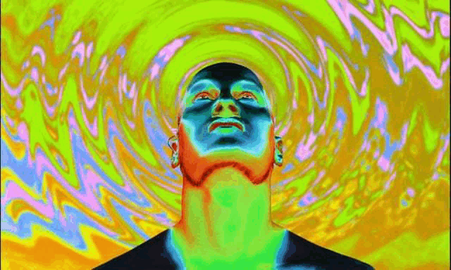 a man 's face is surrounded by a colorful swirl of colors .