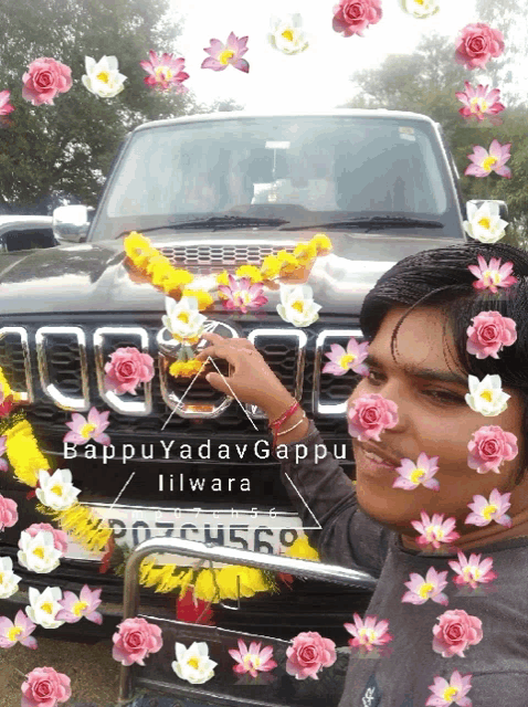 a man stands in front of a jeep with flowers on the front