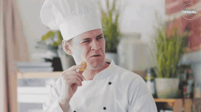 a man in a chef 's hat is eating a piece of food with a sign above him that says storytellers cooking