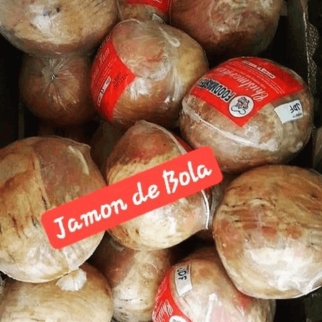 a bunch of jamon de bola balls are wrapped in plastic