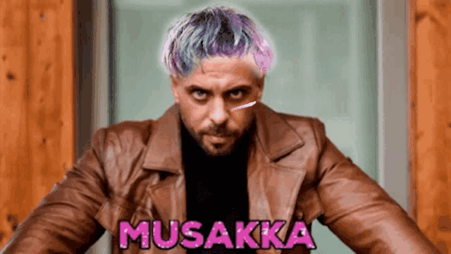 a man with purple hair is wearing a brown leather jacket with musakka written on it