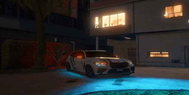 a car is parked in front of a building at night