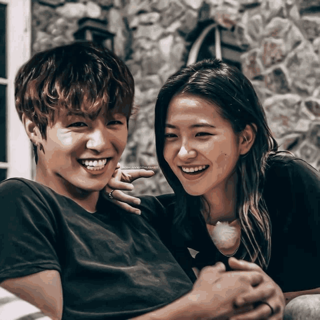 a man and a woman are posing for a picture and the girl is smiling