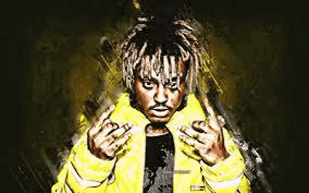 juice wrld is wearing a yellow jacket and making a middle finger sign .