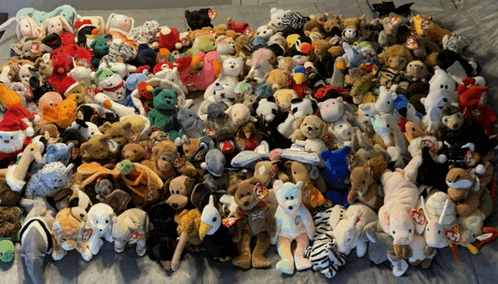 a pile of stuffed animals including a zebra