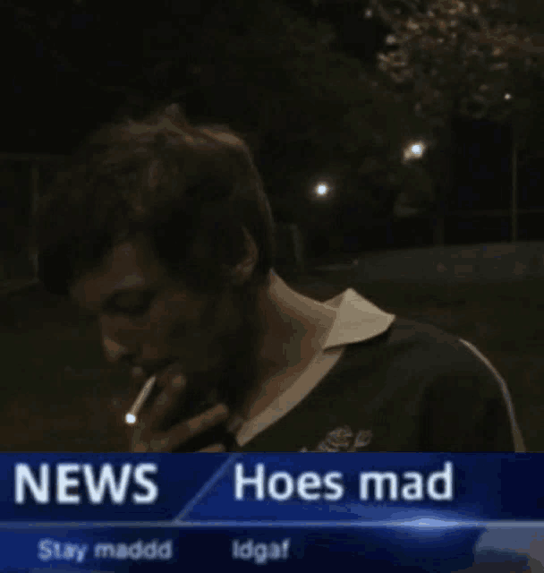 a man is smoking a cigarette in front of a news headline that says hoes mad