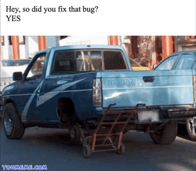 a blue nissan truck with a cart attached to it