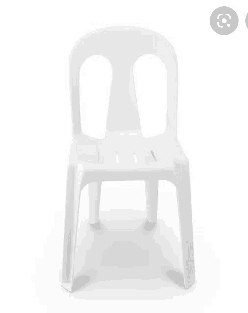 a white plastic chair with holes in the back sits on a white background