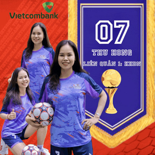 a woman holding a soccer ball in front of a banner that says vietcombank on it