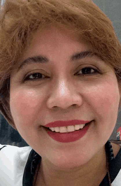 a close up of a woman 's face with red lipstick