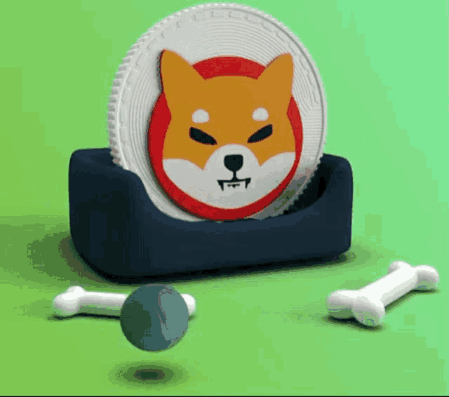 a shiba inu coin is sitting on top of a blue holder next to a ball and bones .