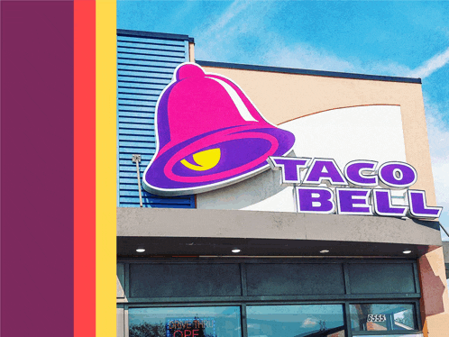 the outside of a taco bell restaurant with a purple bell sign