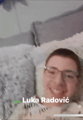 a man with glasses and the name luka radovic on the bottom right