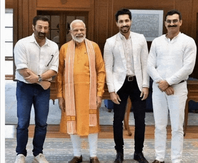 a group of men standing next to each other with one wearing a beard