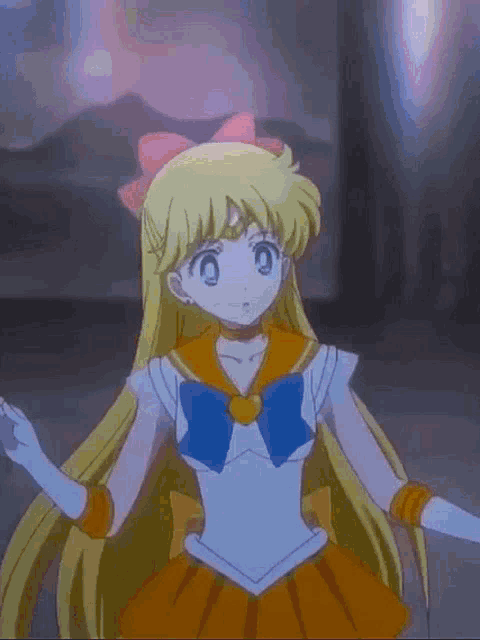 a girl with long blonde hair and a blue bow on her head is wearing a sailor moon outfit .