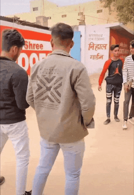 a group of people standing in front of a sign that says shree on it