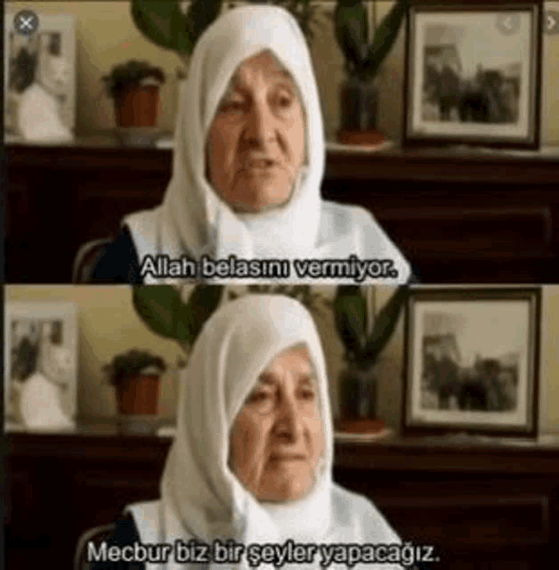 an elderly woman wearing a hijab is sitting in front of a table and talking .