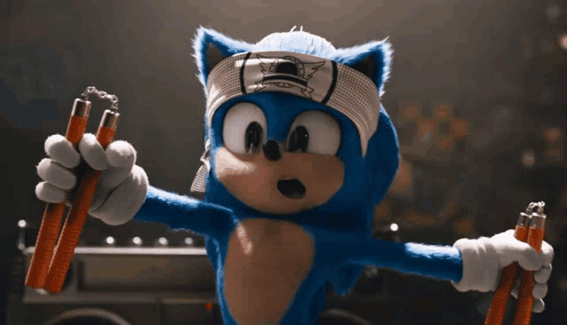 sonic the hedgehog is wearing a karate headband and holding a pair of nunchucks