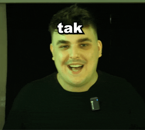 a man with a microphone on his neck has the word tak on his forehead