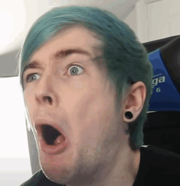 a man with blue hair is making a surprised face with his mouth open