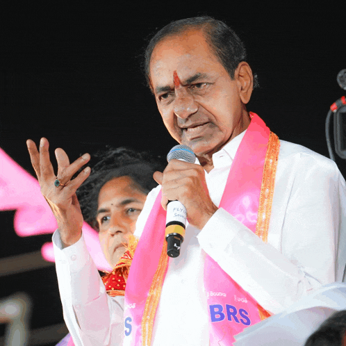 a man with a pink sash that says brs on it