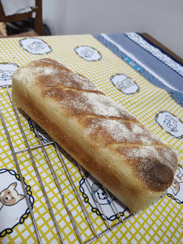 a loaf of bread is sitting on a cooling rack