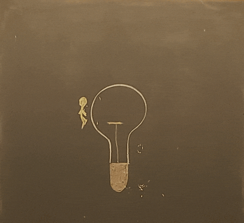 a drawing of a light bulb on a black board