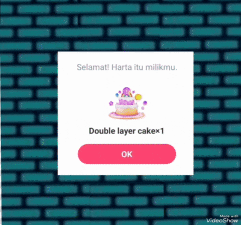 a screenshot of a video showing a double layer cake with an ok button