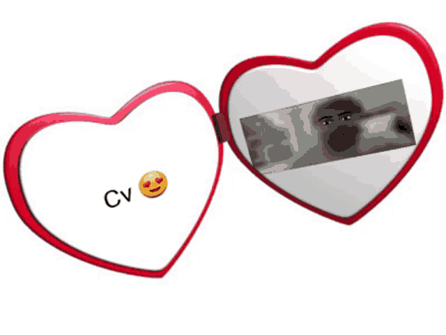 a heart shaped mirror with cv written on the front