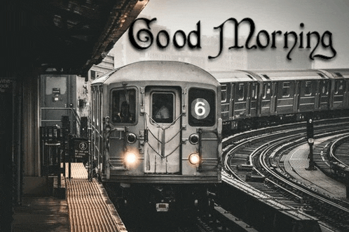 a train is pulling into a train station with the words `` good morning '' written on it .