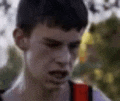 a close up of a man 's face with a backpack on .