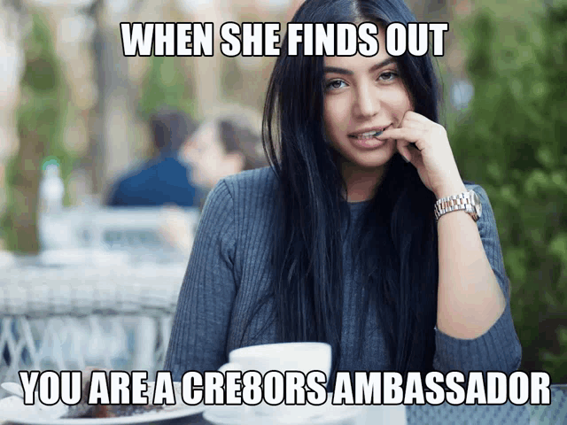 a woman is sitting at a table with a meme that says when she finds out you are a cre8ors ambassador