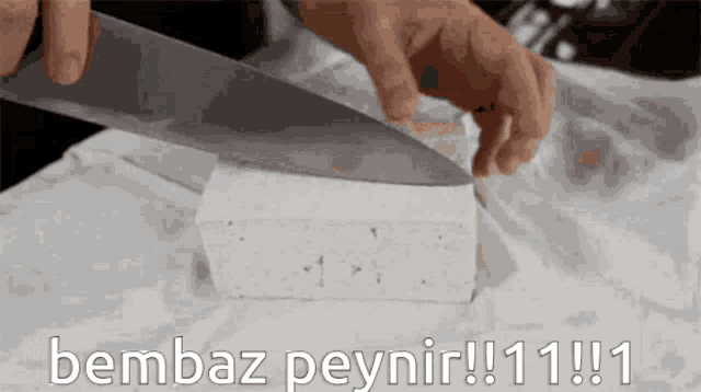 a person is cutting a piece of cheese with the words bembaz peynir written below it