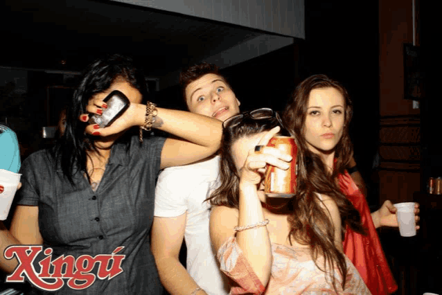 a group of people are posing for a photo with the word xingu on the bottom right