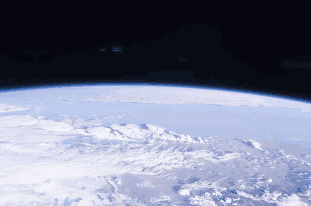 a view of the earth from space with a dark sky