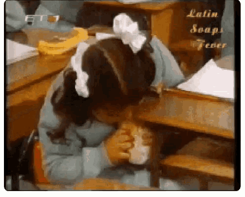 a girl with a bow in her hair is sitting at a desk in a classroom with latin soap tener written on the bottom