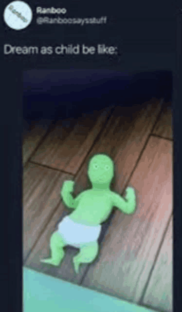 a green baby in a diaper is laying on a wooden floor with the caption dream as child be like