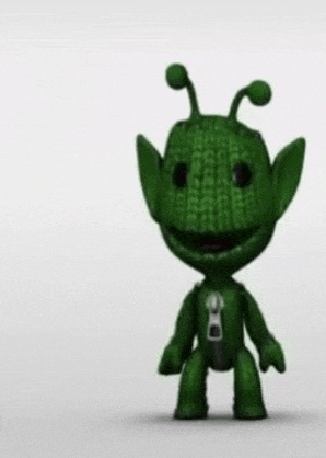 a green toy with a zipper on its chest is standing on a white background .