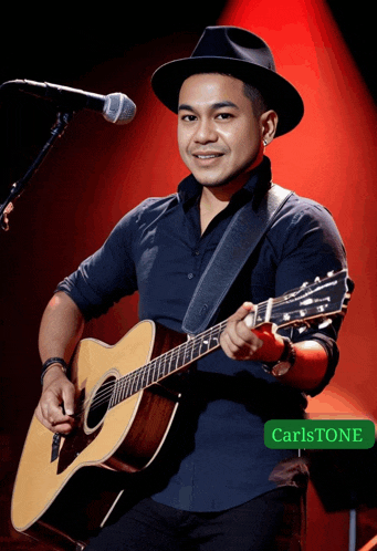 a man playing an acoustic guitar with the name carlston on the bottom right