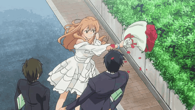 a girl in a white dress is throwing a bouquet of roses at a man