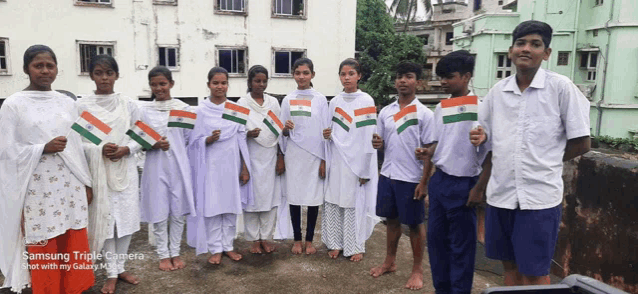 a group of children holding up indian flags with a samsung triple camera shot