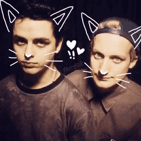 a man and a woman are posing for a picture with cat ears drawn on their faces .