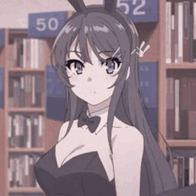 a girl in a bunny outfit is standing in front of a bookshelf in a library .