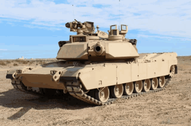 a military tank is parked in the dirt with a blue sky behind it