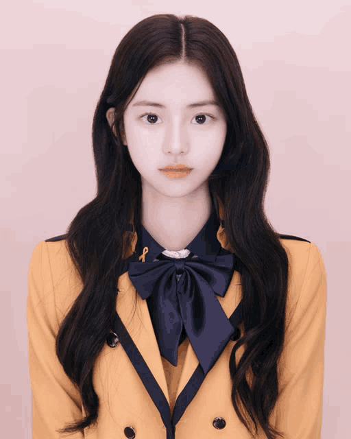 a girl with long hair wearing a yellow school uniform