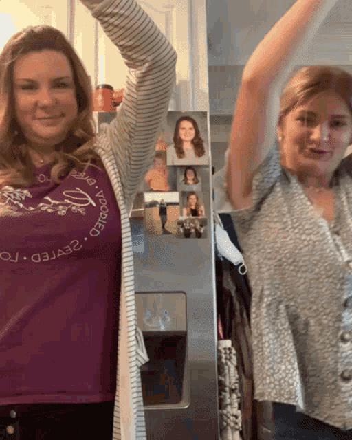 two women are standing in front of a refrigerator and one has a shirt that says ' i love you world '