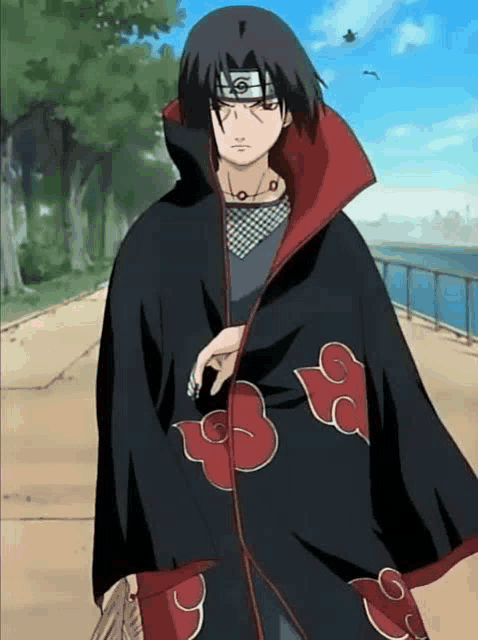 itachi uchiha is wearing a black and red cloak with clouds on it .