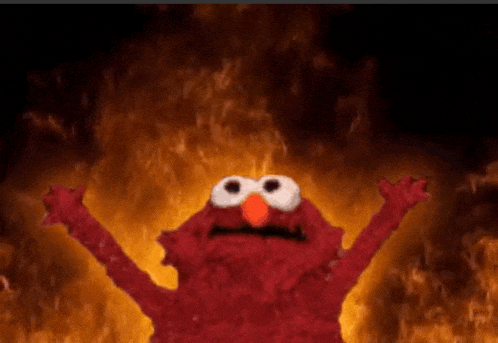 elmo from sesame street is standing in front of a fire with his arms in the air .