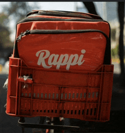 a red rappi bag sits on a red crate